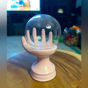 Pink hand display with globe